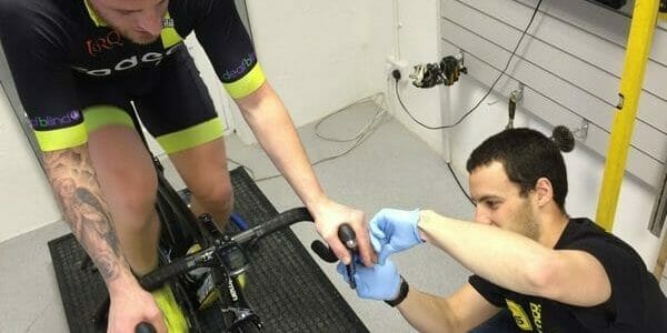 Man on bike taking blood lactate test